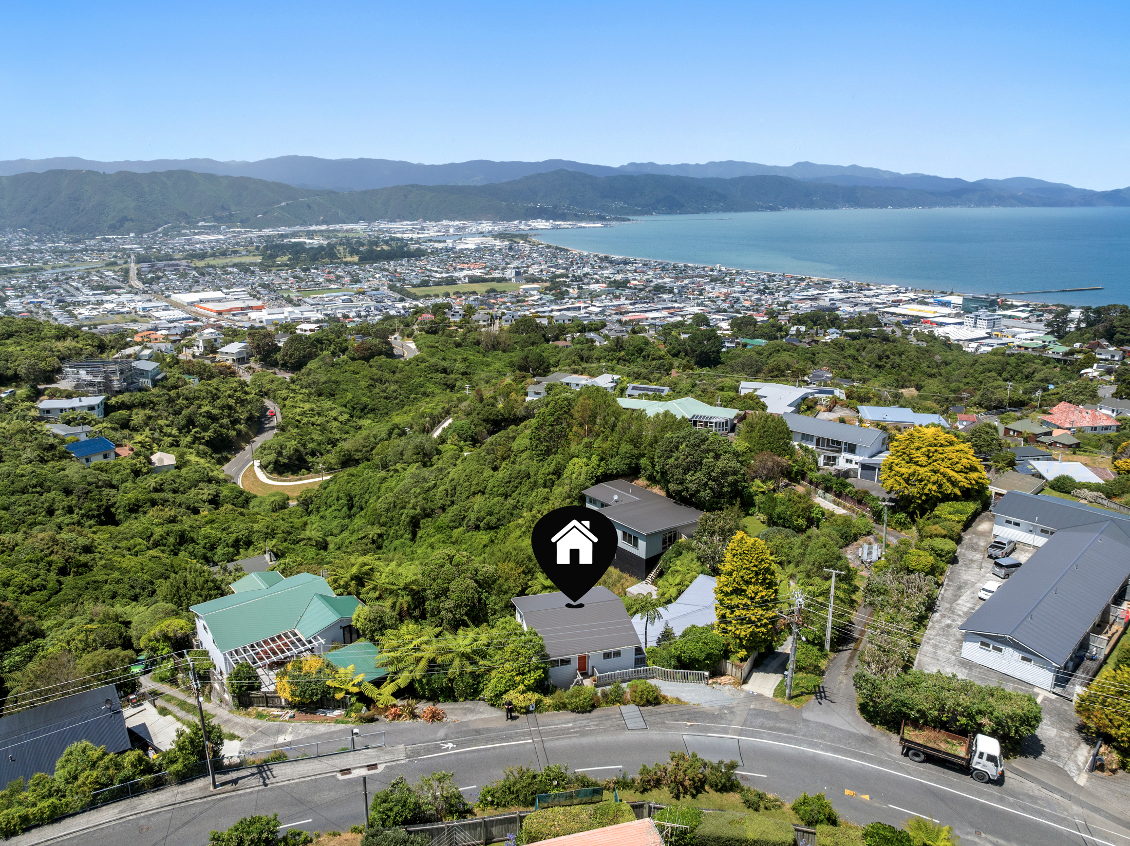 Aerial view of hillside property overlooking harbour